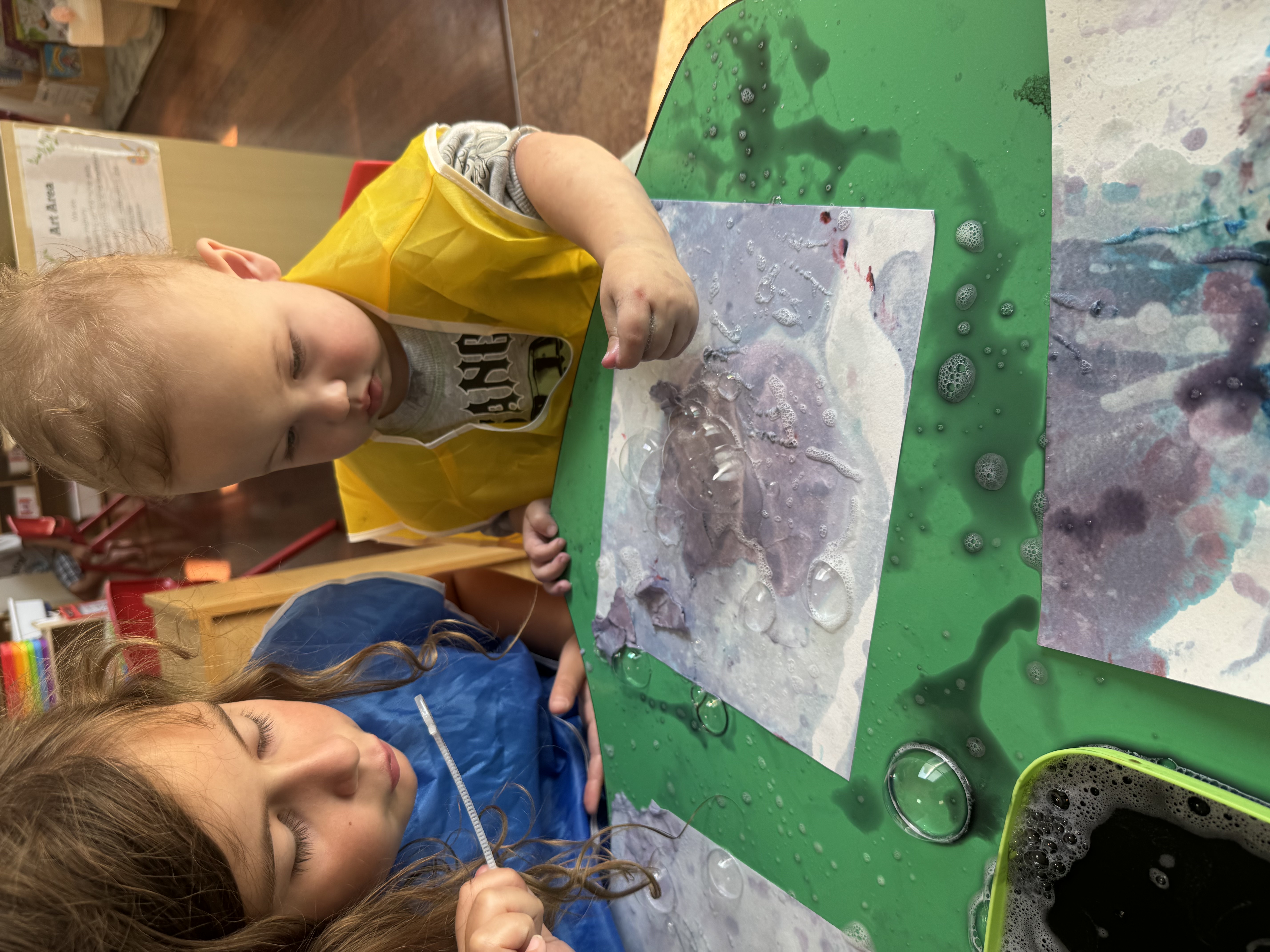Children playing with paint and bubbles